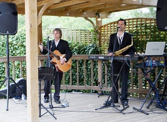 Russ Davey & Anthony Herridge playing music on a deck deck
