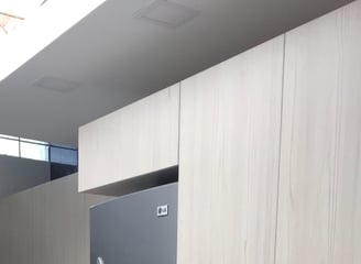 a kitchen with a refrigerator showcasing renewed cabinets