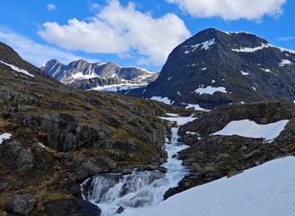 Trollstigen plateau viewpoint with snow and waterfall