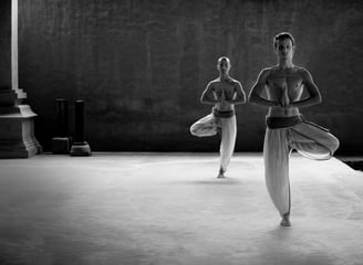 two people are doing yoga exercises on a platform