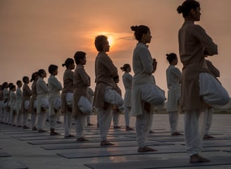 a group of people standing in a line doing Yoga