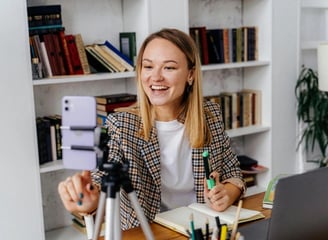 woman teaching online setting up her phone
