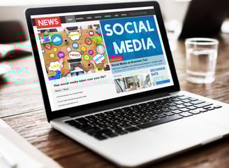 a laptop computer screen with a news pager on the screen
