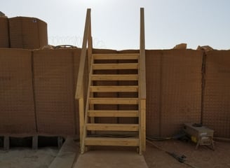 Stairs leading up unto a dirt wall