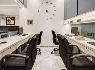 a large office with a long desk and chairs