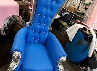 a blue chair with a blue chair and a pink chair