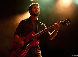 a man with a beard and a guitar