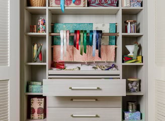 a closet with a shelf full of books and a toy