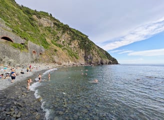 Rocky beach in Riomaggiore Italy with mountain