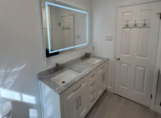 a new bathroom remodel with a large mirror and a sink