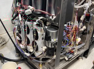 nside view of BUNN Bean to Cup coffee machine during service showing wiring and boiler components.