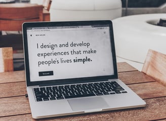 A desktop computer showing a modern business website with a clean layout, featuring a large header i