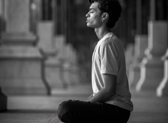 a man sitting on the ground doing meditation