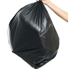 a person holding a black bag of garbage bags