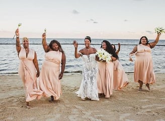 a bride and groomsmid are posing for a photo