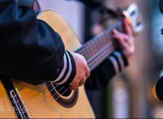 Moss.E playing the nylon-string guitar outside
