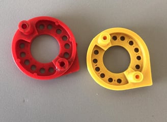 two red and yellow plastic rings with holes in them