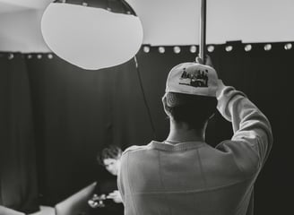 Man making a C-stand in a podcast studio.