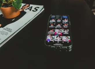 A phone displaying Instagram and social media content for podcasts.