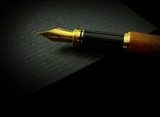 a pen and a pen on a black background