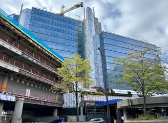 a large building with a crane in the background