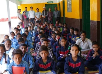 Children sitting with stationary