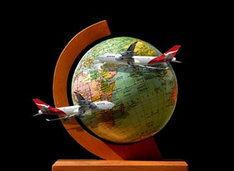 a globe globe with airplanes flying over a globe