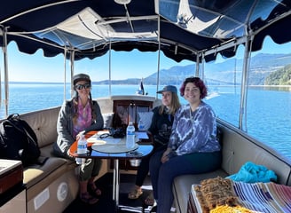 a group of people sitting on an eco-friendly all electric boat clients team building