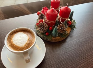 a cup of coffee with a candle on a table
