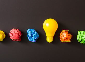 a light bulb bulb in a row of crumpled paper
