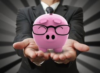 a man in a suit and glasses holding a piggy piggy piggy pig