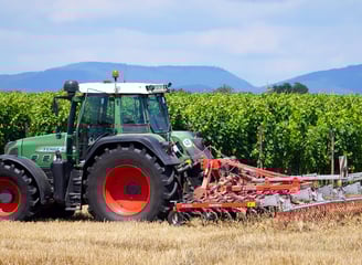 a tractor with a plow on a field