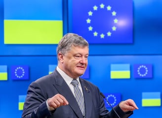 Petro Poroshenko in a suit and tie is giving a speech