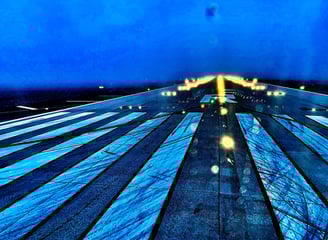 a plane taking off from the runway at night