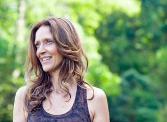 a woman with a brown tank top and a black tank top
