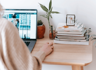 Image of a woman at her laptop working from home