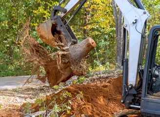 a man is taking a break from a tree stump removal