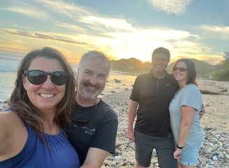 a group of people standing on a beach