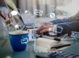 Person working on a laptop with superimposed icons signifying digital marketing, online communicatio
