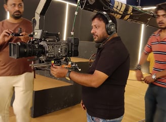 a man in a black shirt is holding a camera and a camera