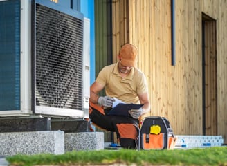 a man sitting on a bench reading a book