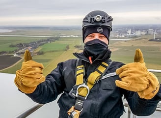 a man in a helmet and safety gear on a rope