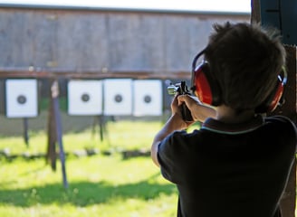 Young boy shooting static targets on the range