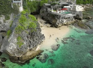 Nestled under Uluwatu’s cliffs, Suluban Beach
