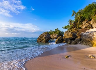 Padang Padang Beach with a rocky shore and a blue sky