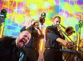 Energetic brass section performing on stage during wedding show