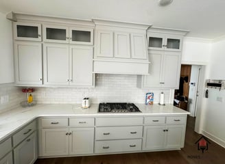 a kitchen with white cabinets and white cabinets