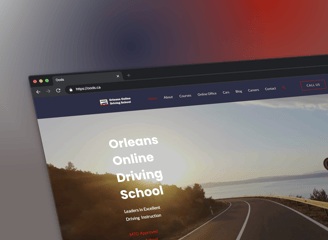 a laptop screen showing a picture of a driving school website page