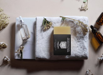 a towel with a bottle of essential oils on it