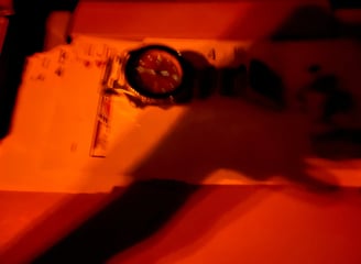 a person holding a clock and a clock on a table